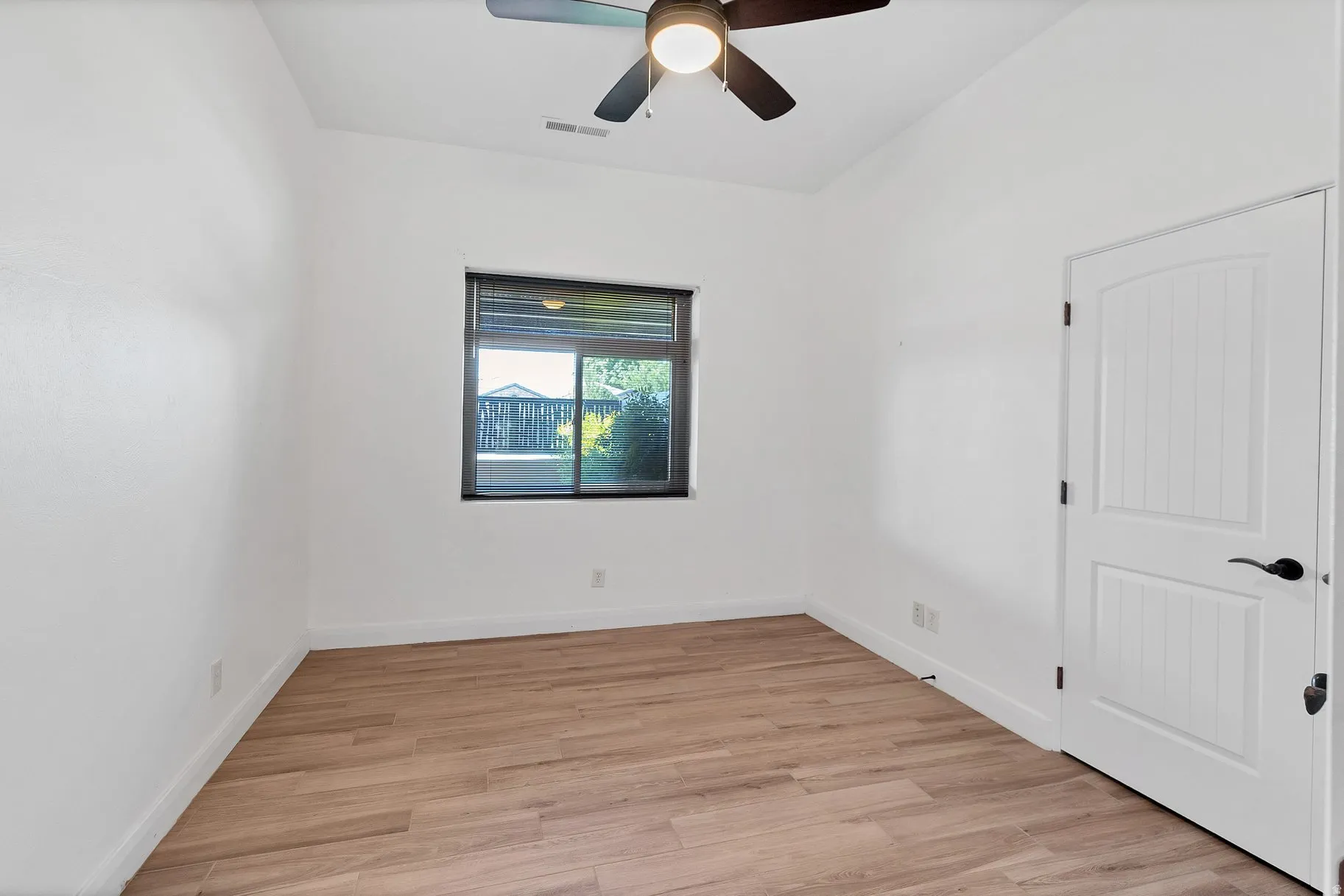 Spare room featuring light wood-style floors and a ceiling fan