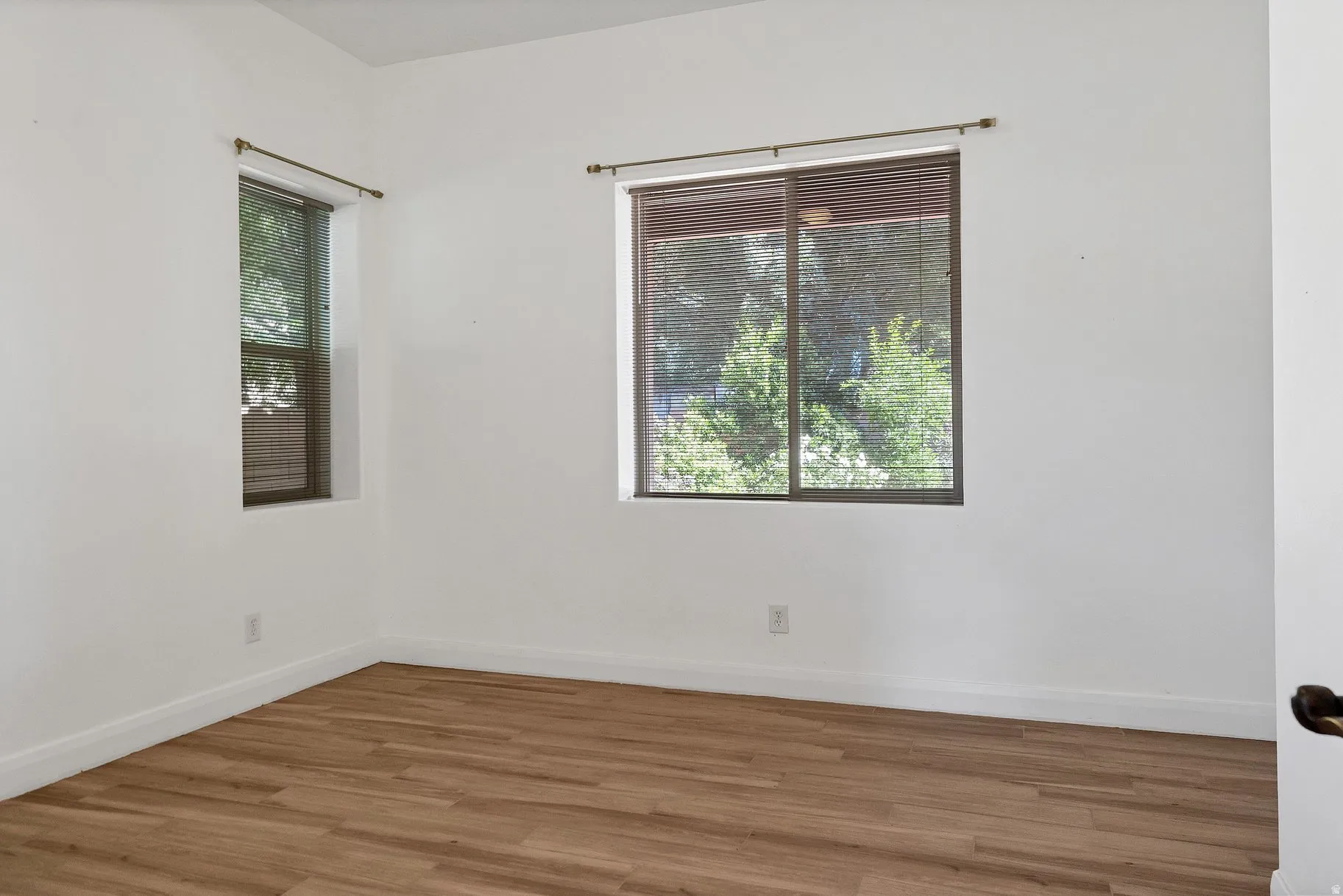 Spare room with wood finished floors and baseboards