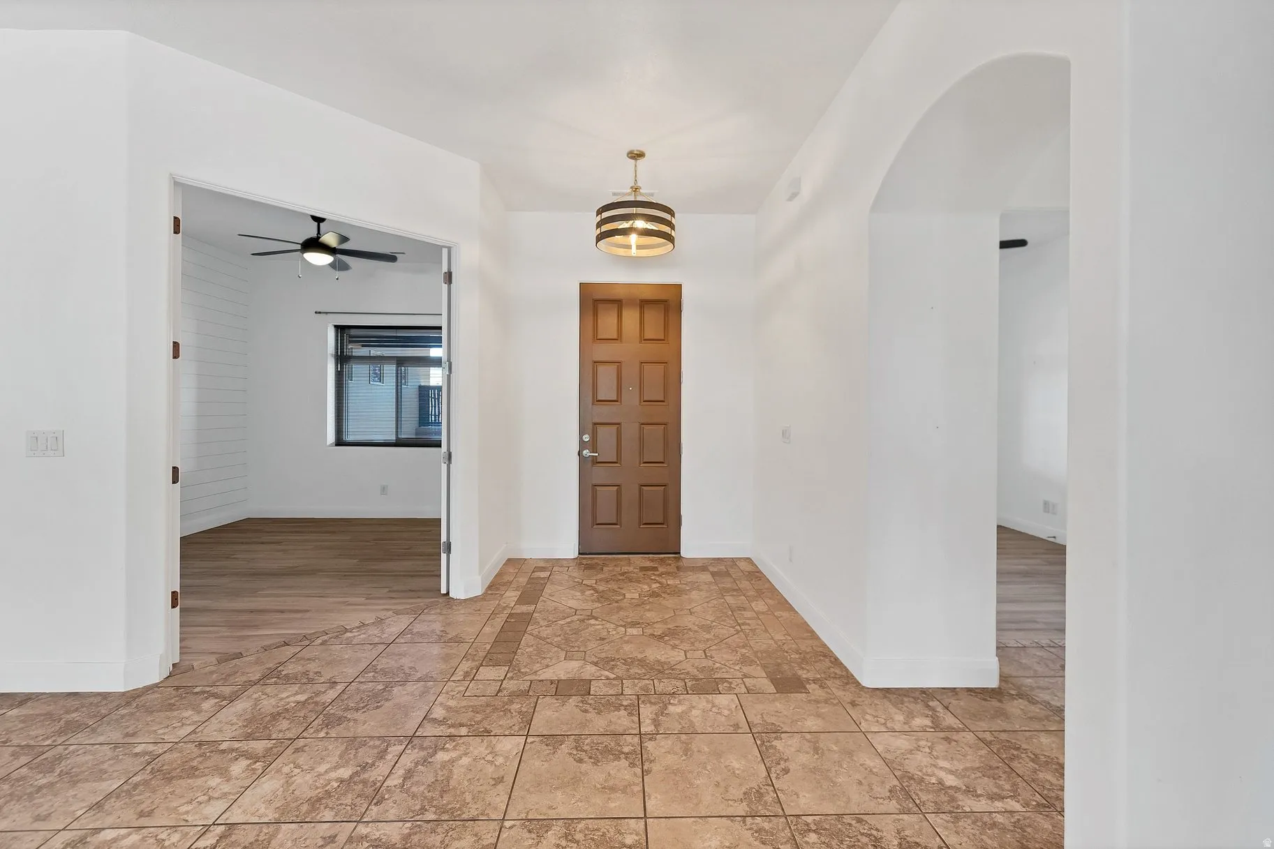 Foyer entrance featuring baseboards and a ceiling fan