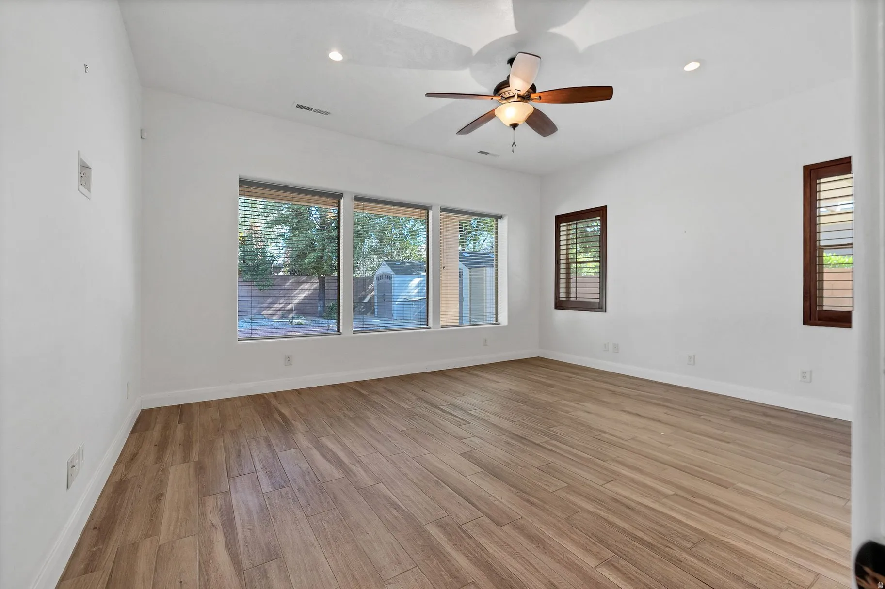 Spare room with light wood-style flooring, ceiling fan, and recessed lighting