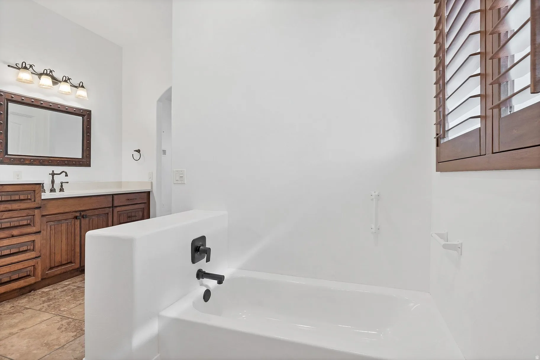 Bathroom featuring vanity and a garden tub