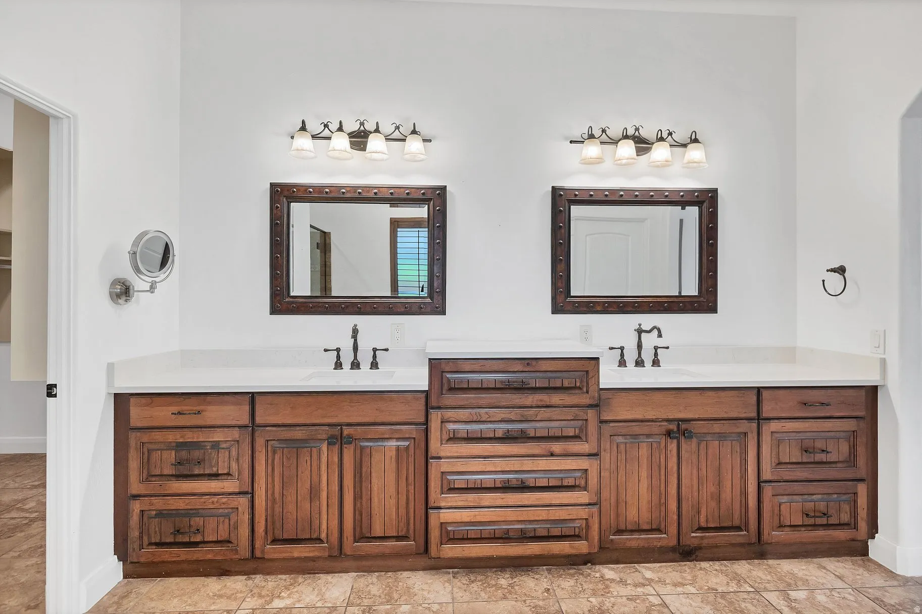 Full bath with double vanity and baseboards