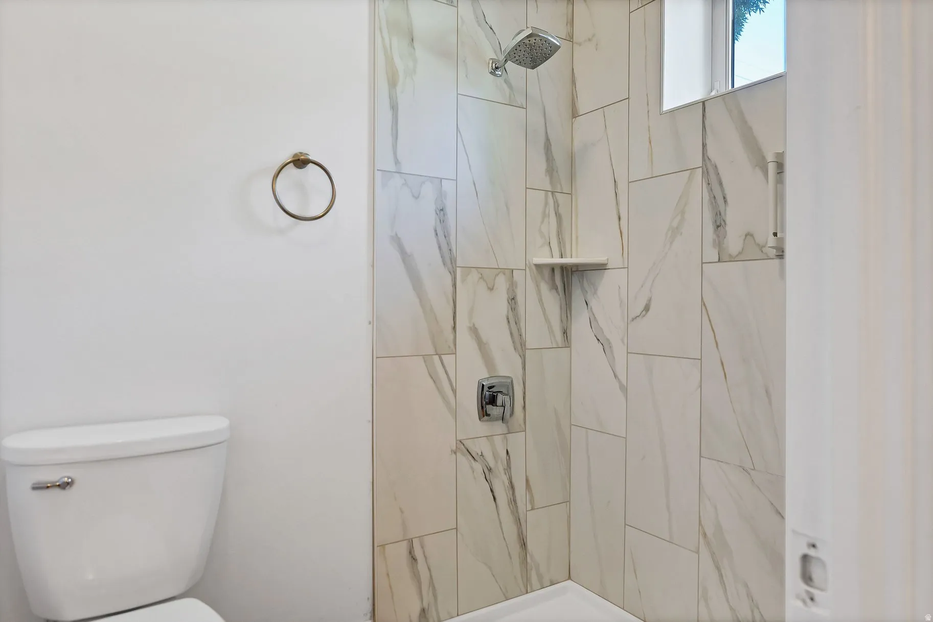 Bathroom with toilet and a stall shower