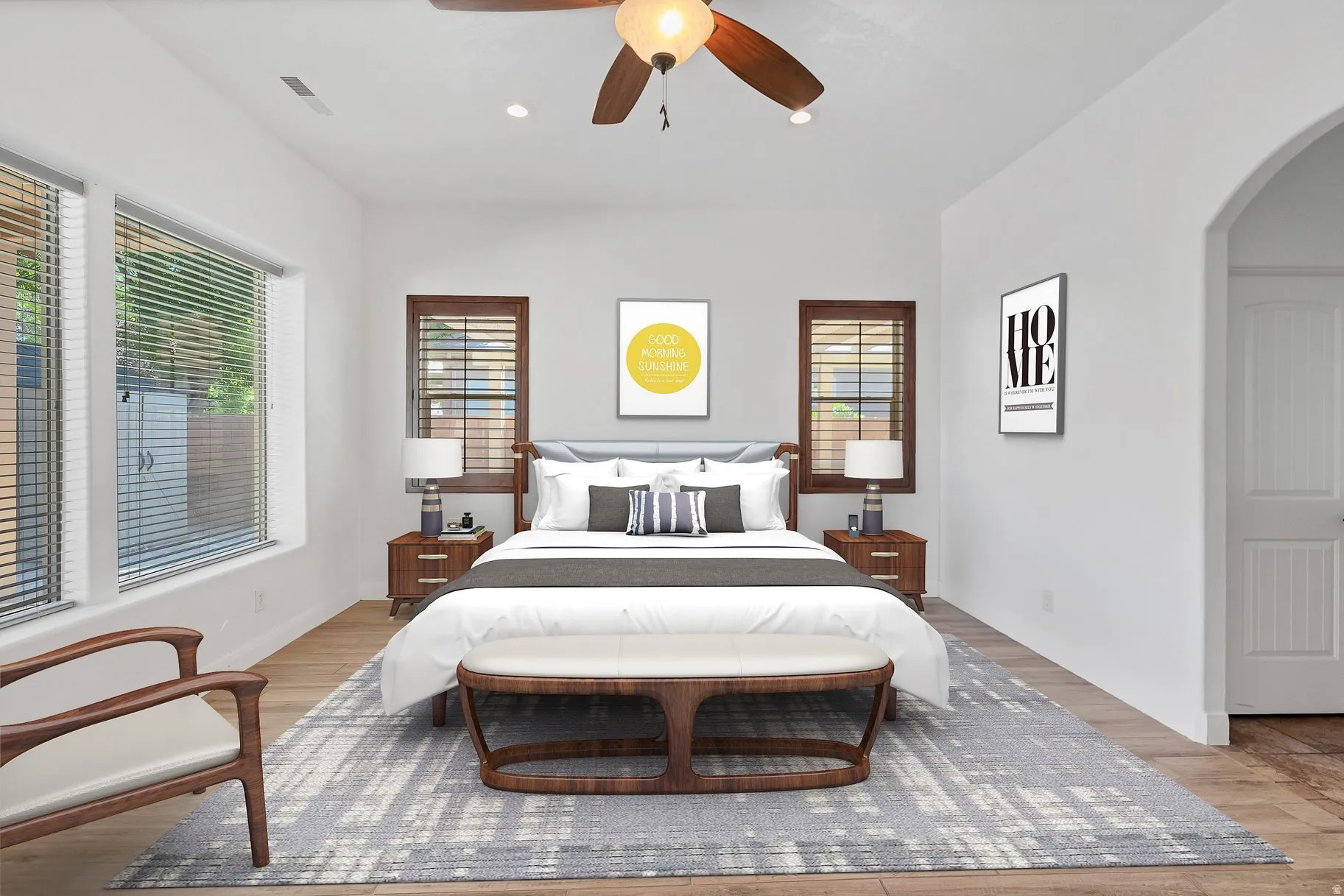 Bedroom with arched walkways, a ceiling fan, light wood-style flooring, and recessed lighting