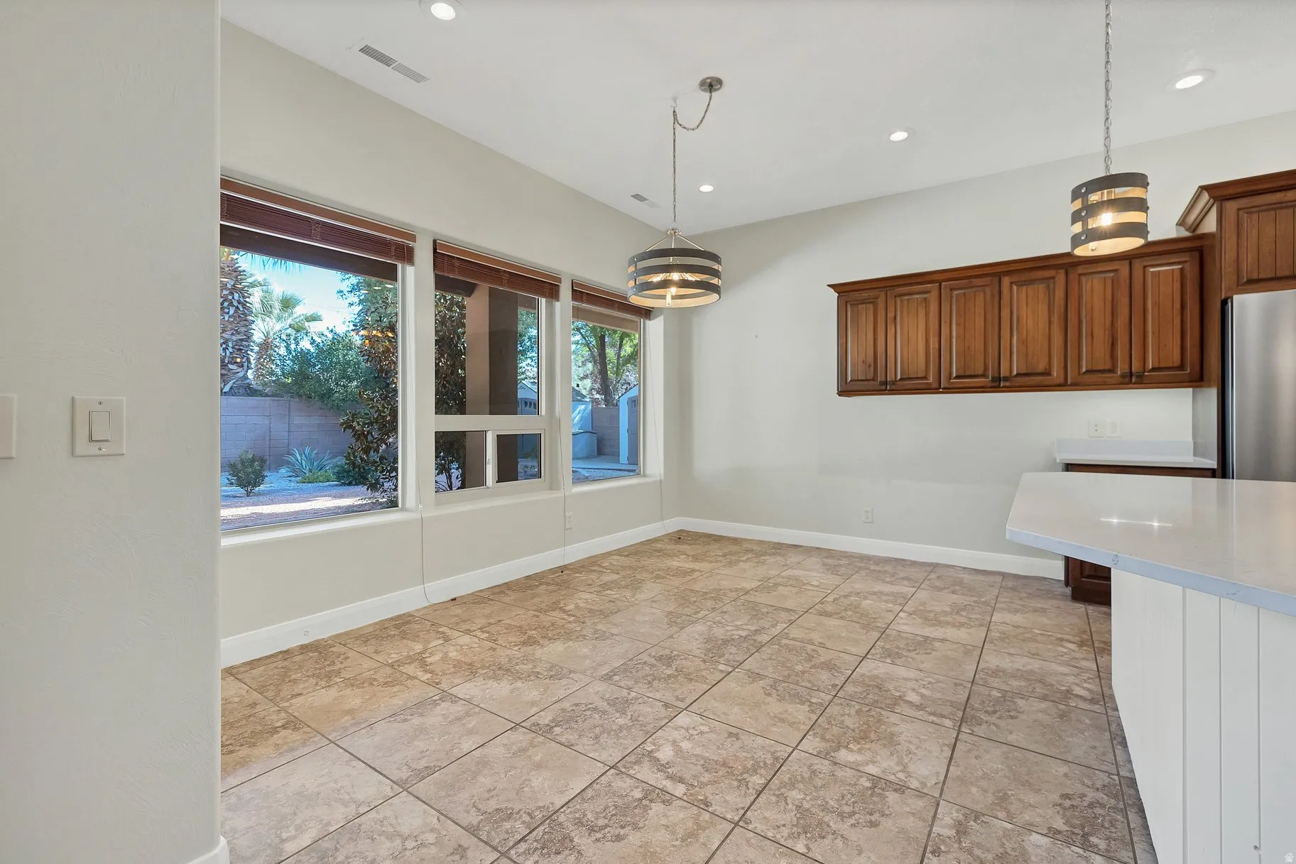 Unfurnished dining area with recessed lighting and baseboards