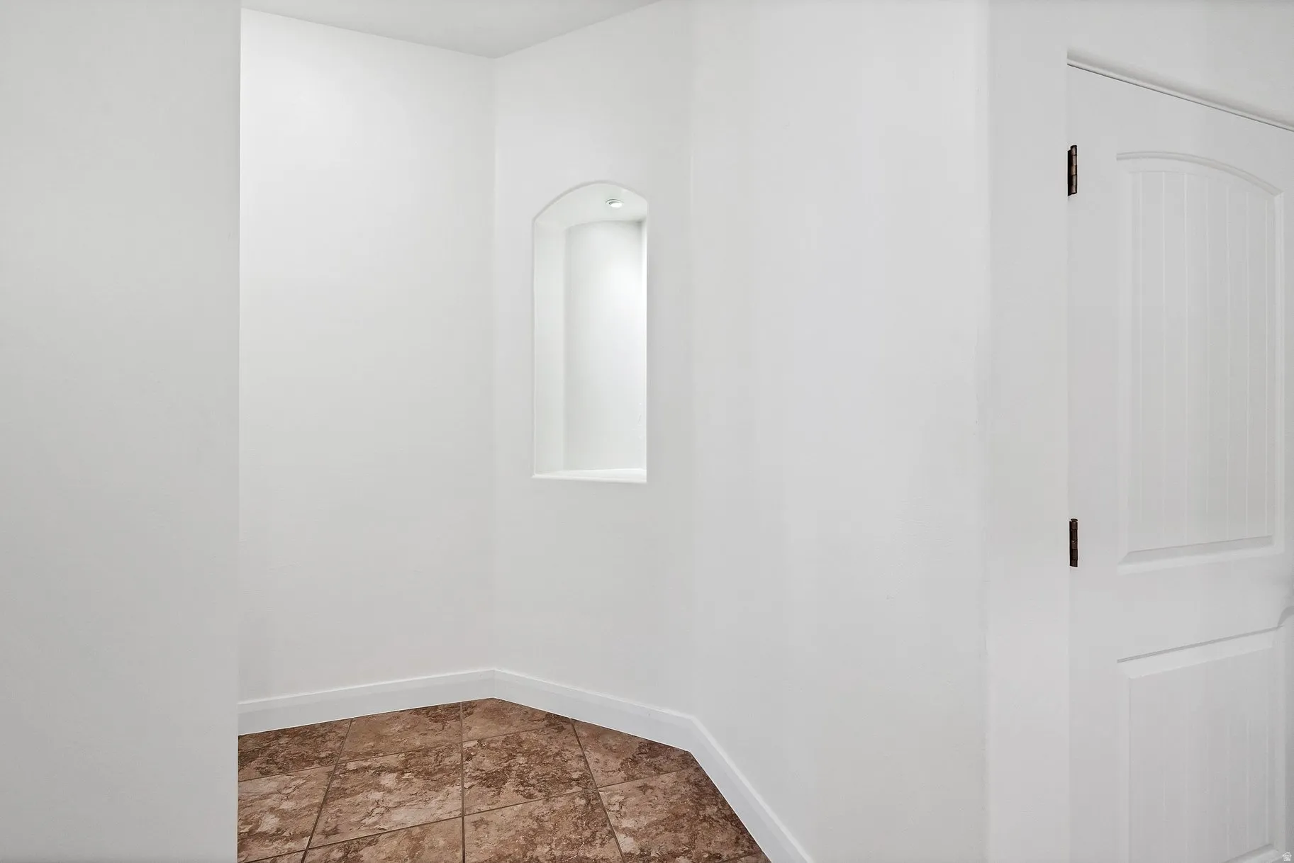 Unfurnished room featuring baseboards