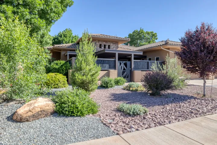 View of front of property with stone siding, stucco siding, and a tile roof