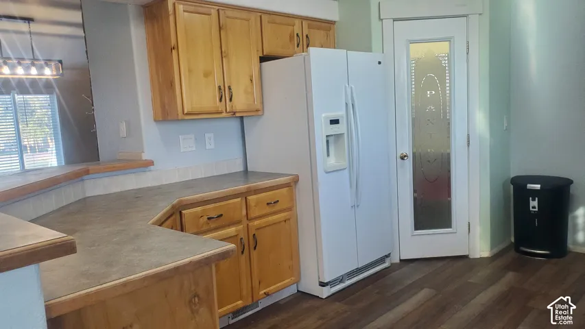 Wood-finish cabinetry paired with solid surface countertops