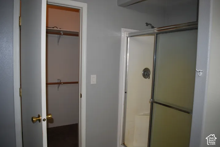 Shower enclosure with sliding glass doors and polished chrome fixtures