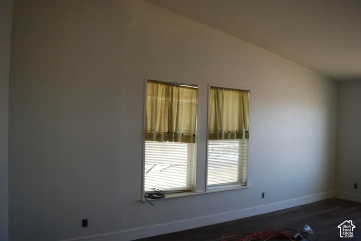 Interior space featuring two windows with horizontal blinds, providing natural illumination