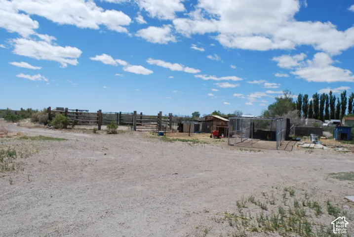 View of yard featuring an outbuilding, a rural view, and exterior structure