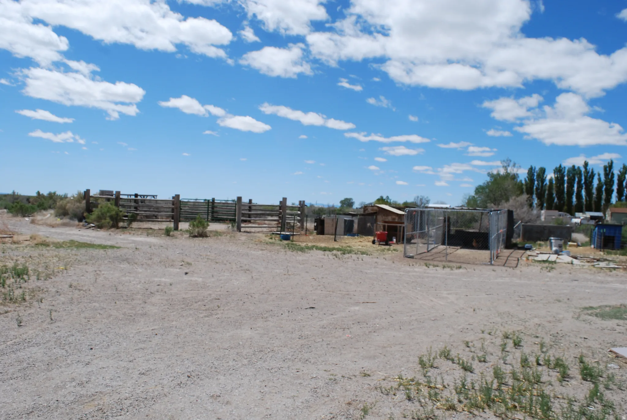 View of yard featuring an outbuilding, a rural view, and exterior structure