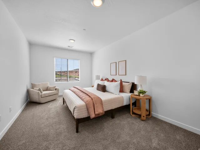 Wall-to-wall carpeting, recessed lighting, and a large window with horizontal blinds