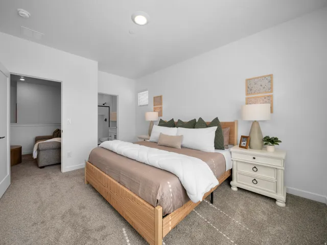Recessed ceiling lighting, plush carpeting, white walls, and a window with horizontal blinds