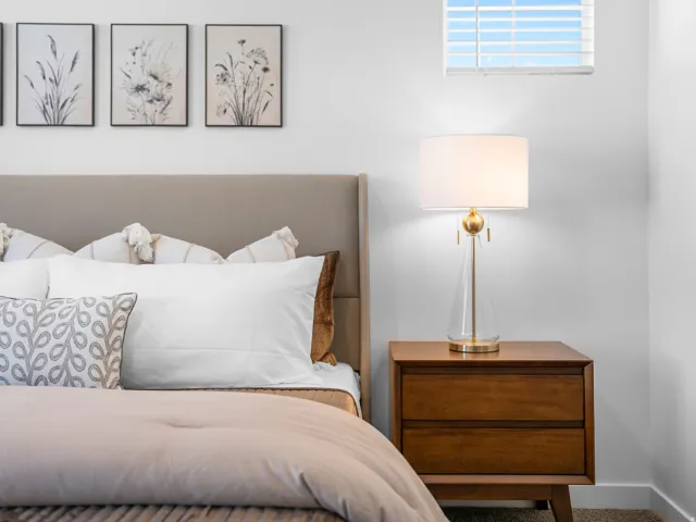 Upholstered headboard with wall-mounted artwork