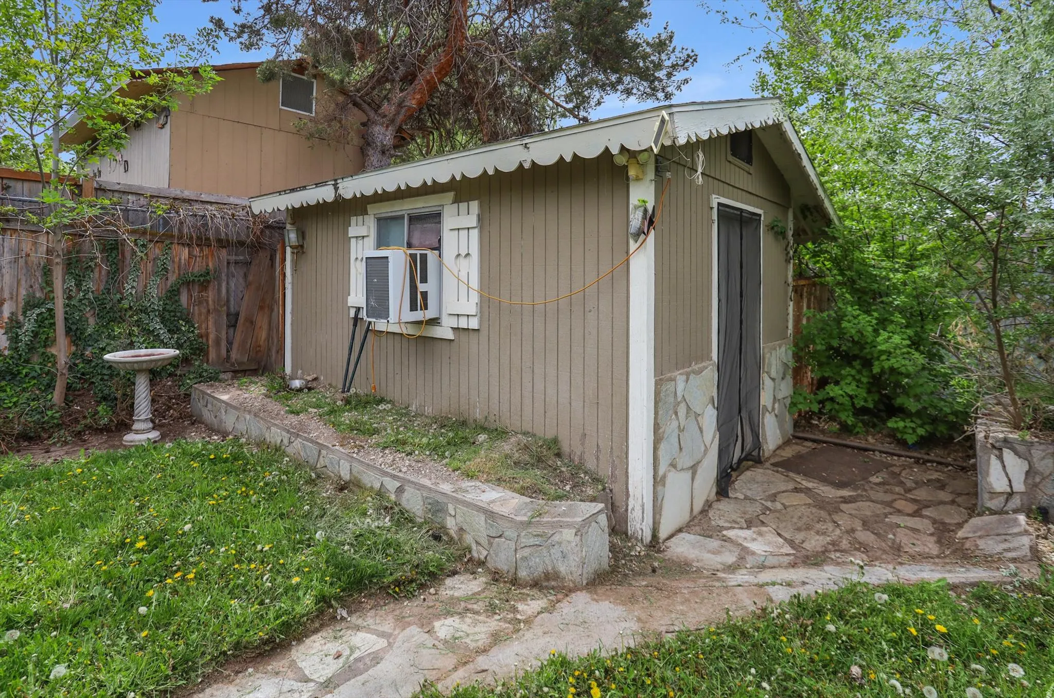 View of home's exterior with an outdoor structure, ADU potential.