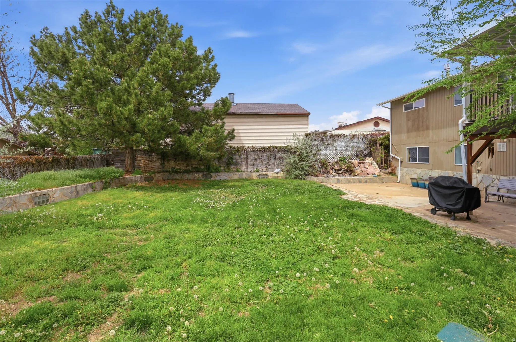 Fenced backyard with a patio