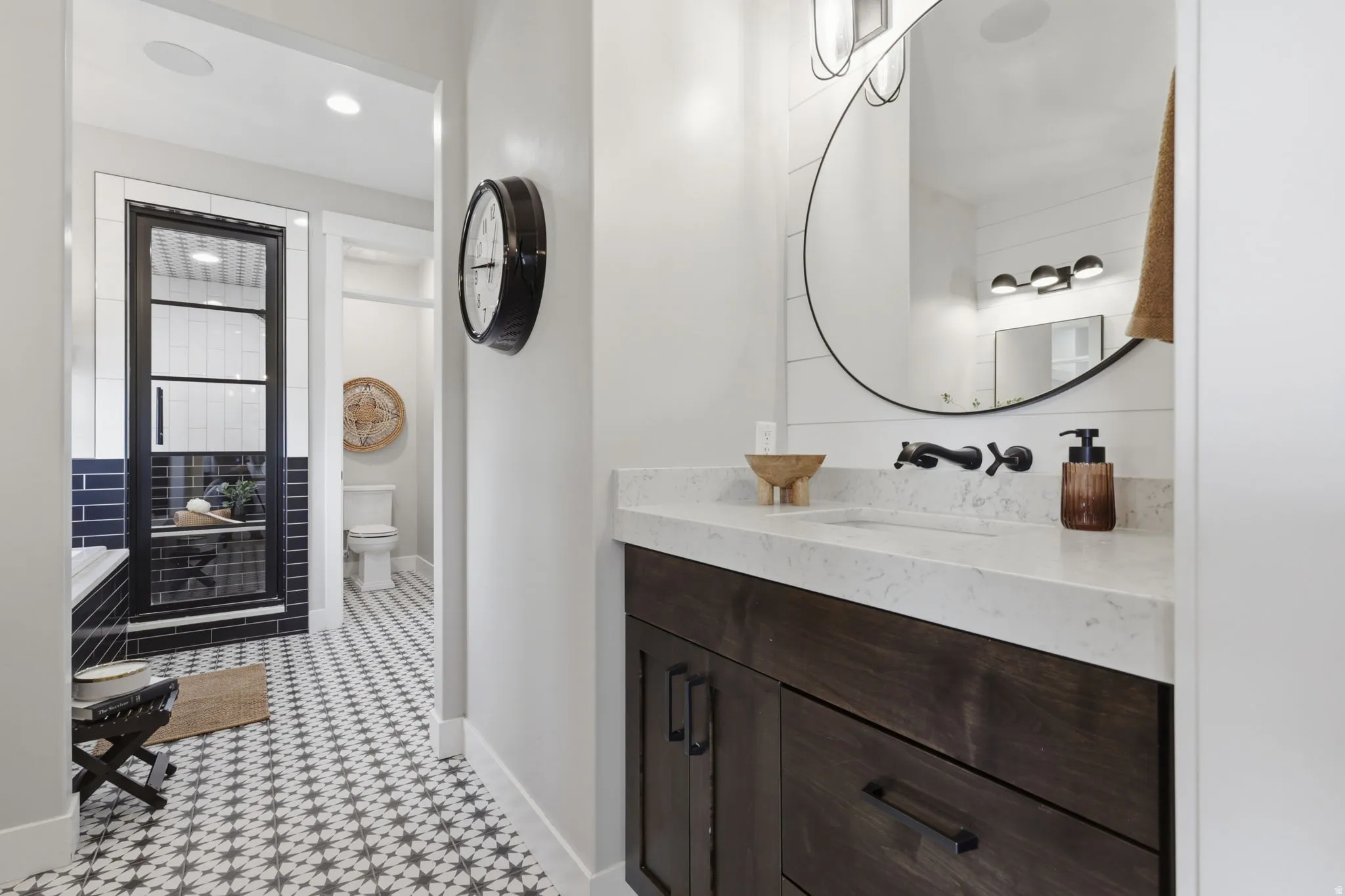 Bathroom featuring vanity, recessed lighting, a stall shower, and light flooring