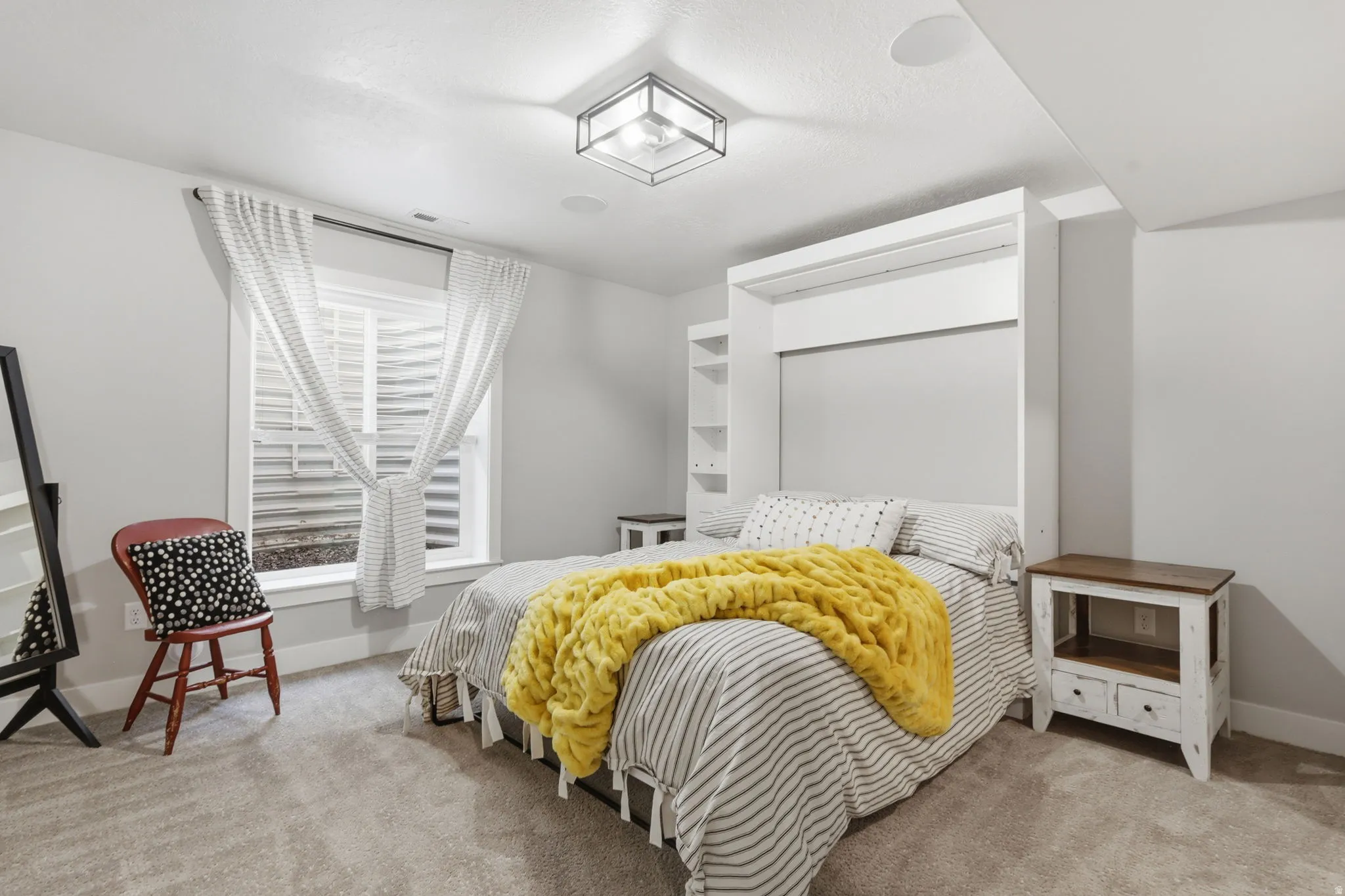 Bedroom with light carpet and baseboards