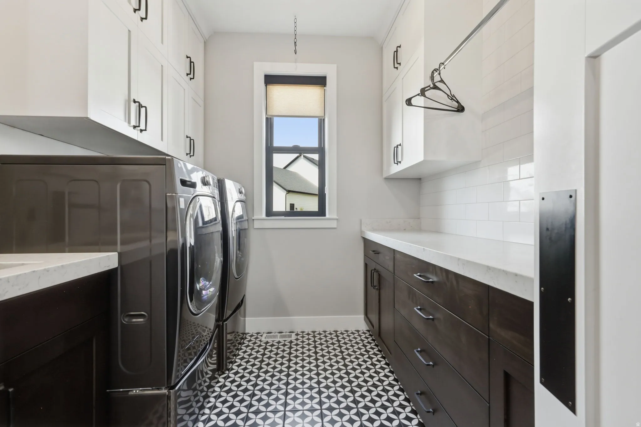 Laundry room with cabinet space and washing machine and clothes dryer