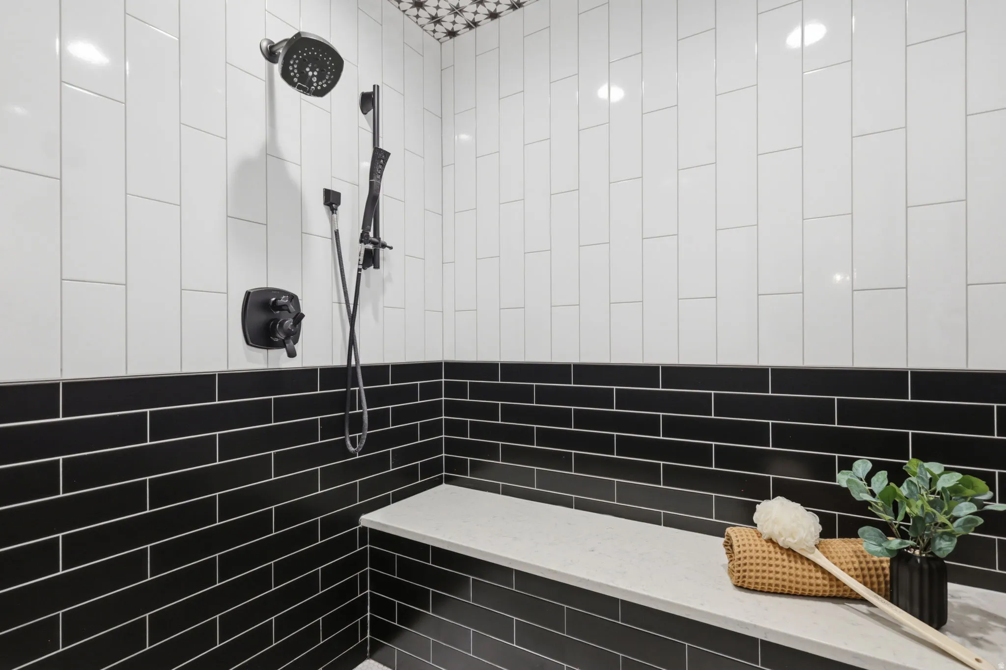 Full bathroom with tiled shower and tile walls