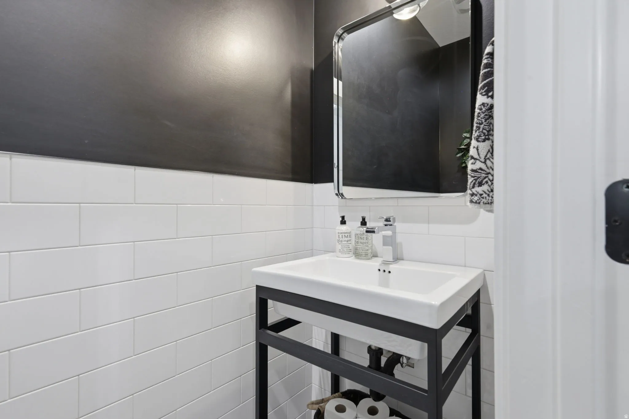 Bathroom with a sink and tile walls