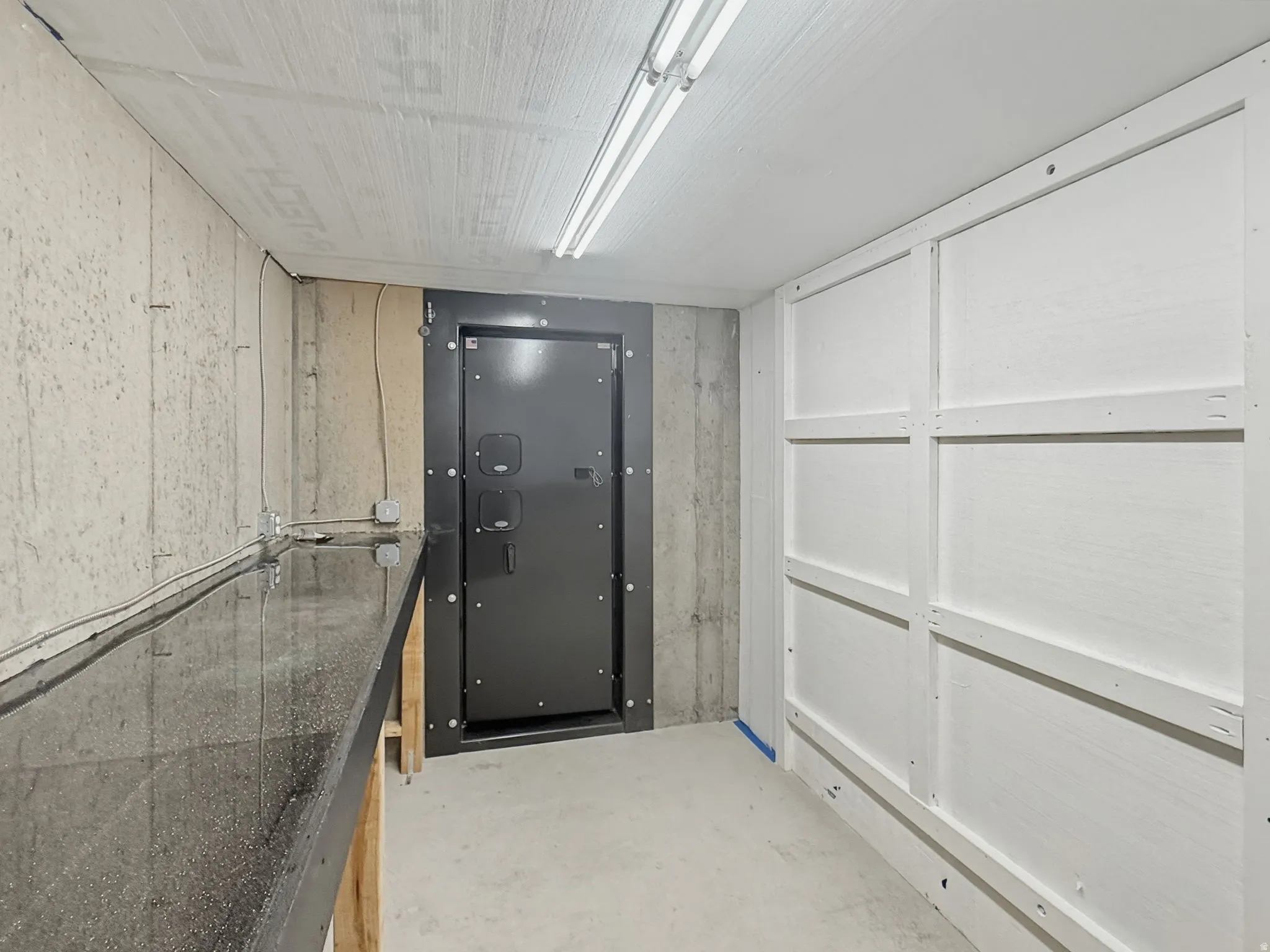 Miscellaneous room with unfinished concrete floors