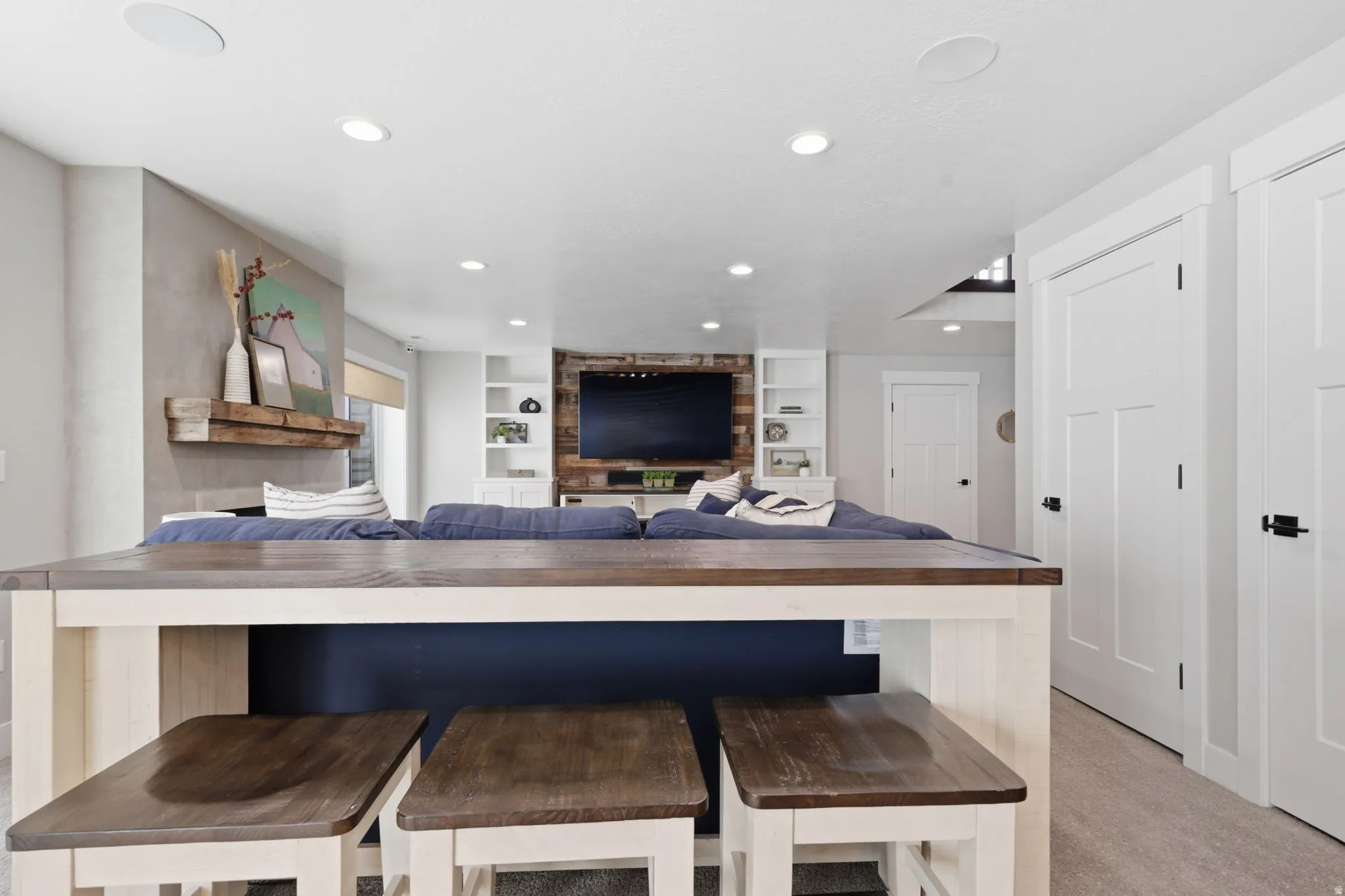 Kitchen featuring built in features, wood counters, recessed lighting, a kitchen bar, and open floor plan