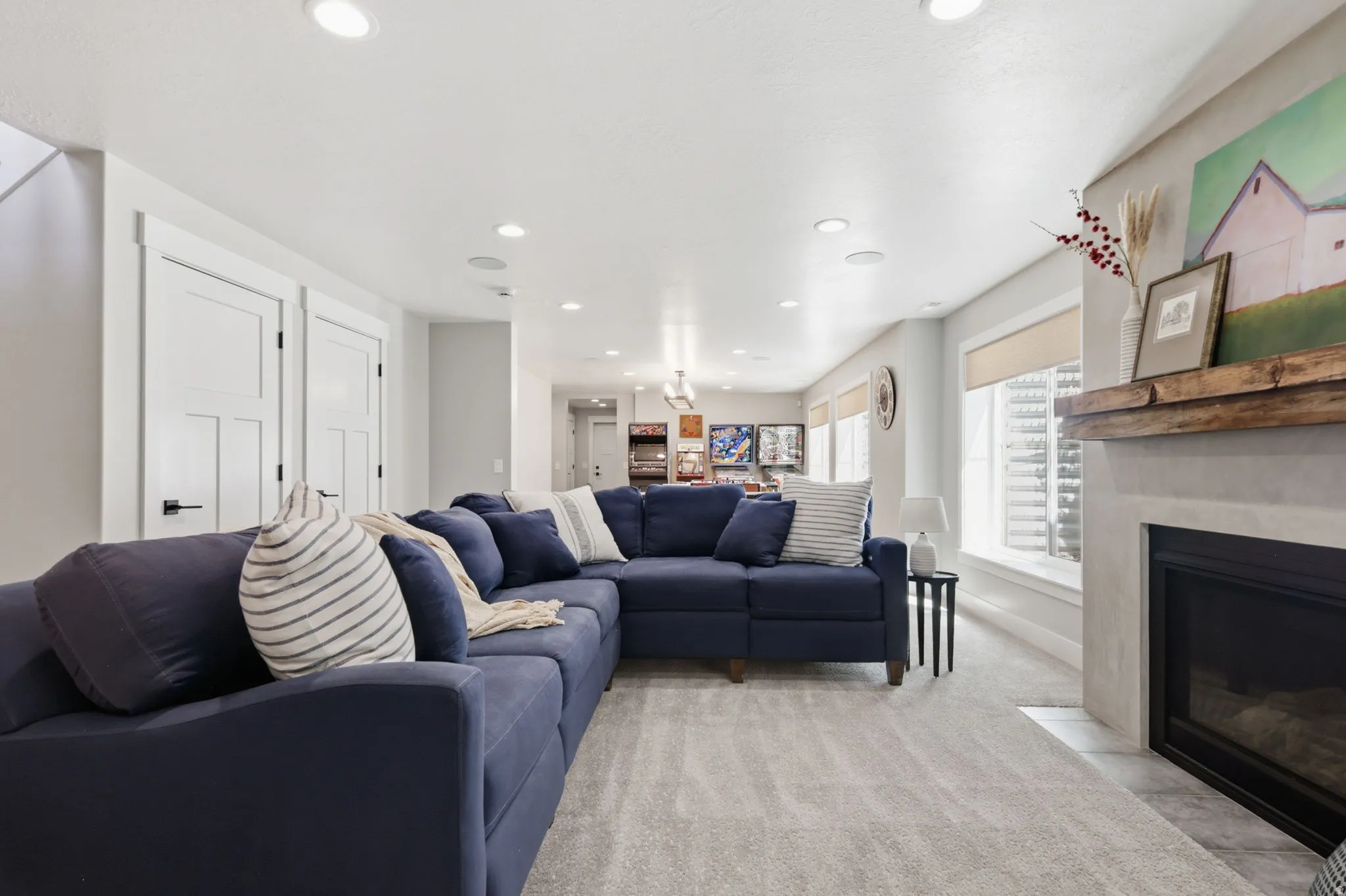 Living room featuring a high end fireplace, light carpet, and recessed lighting