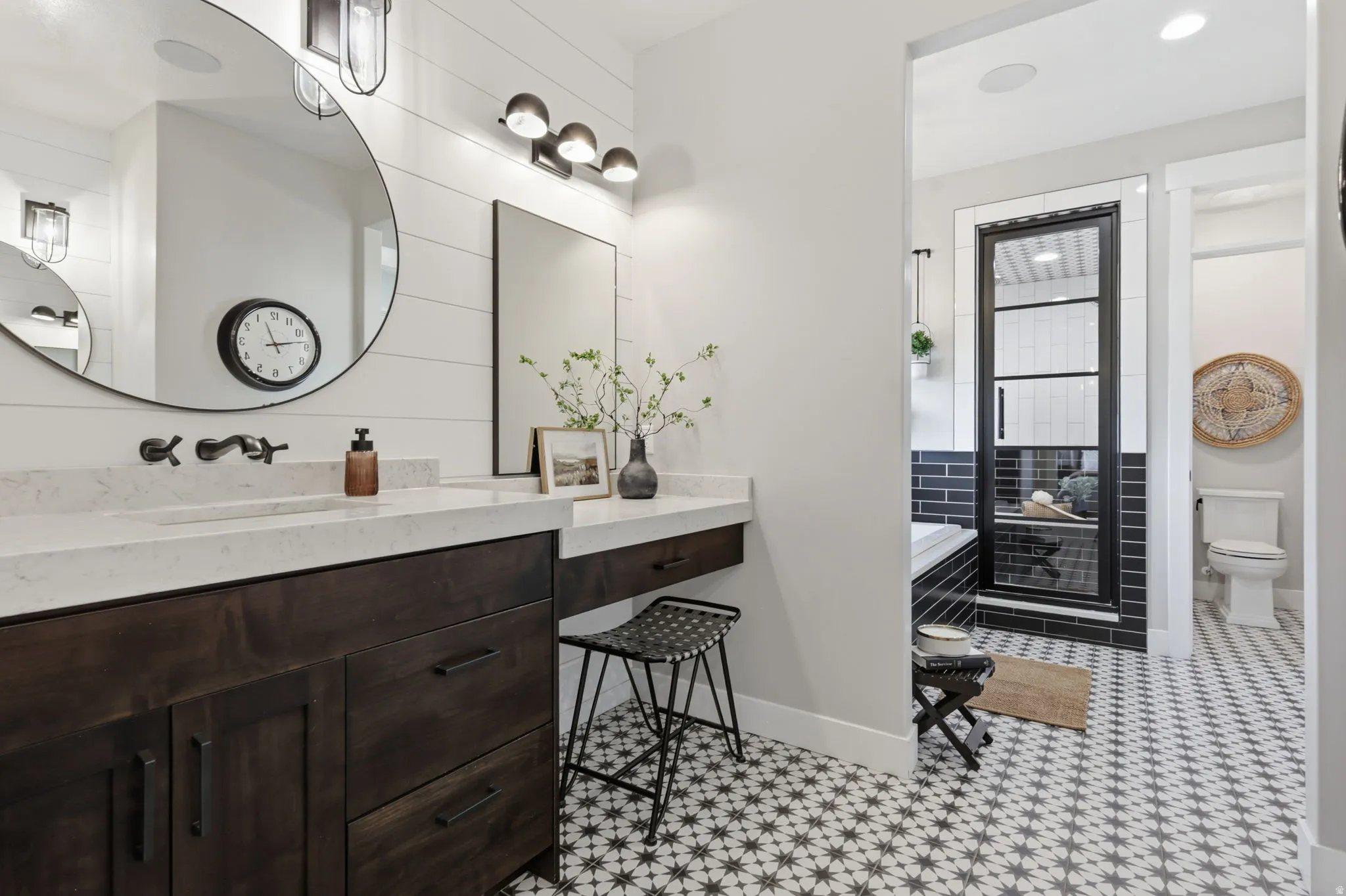 Bathroom with vanity, a shower stall, and a bathtub