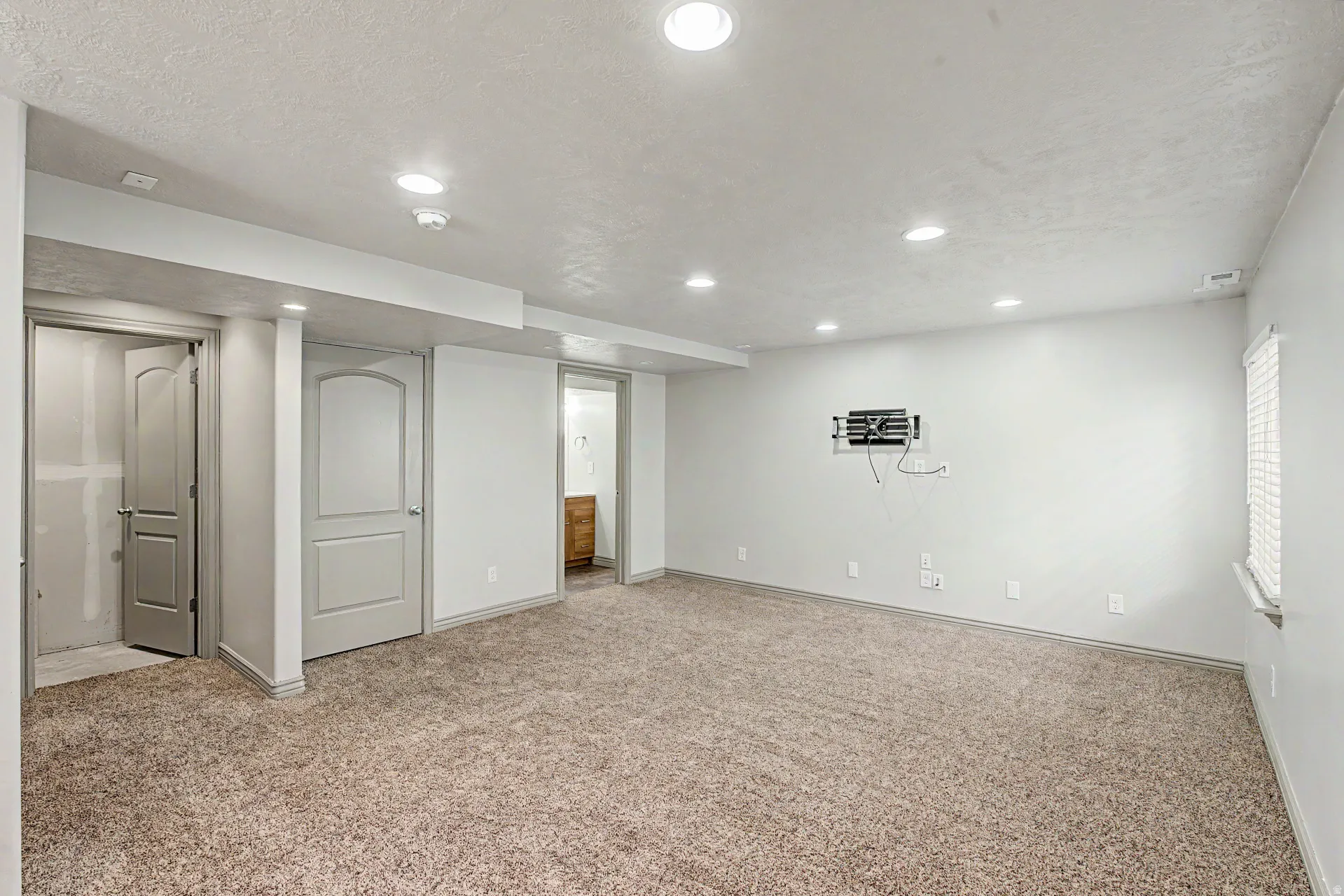 Basement featuring light colored carpet and recessed lighting plus an additional family room and flex space.