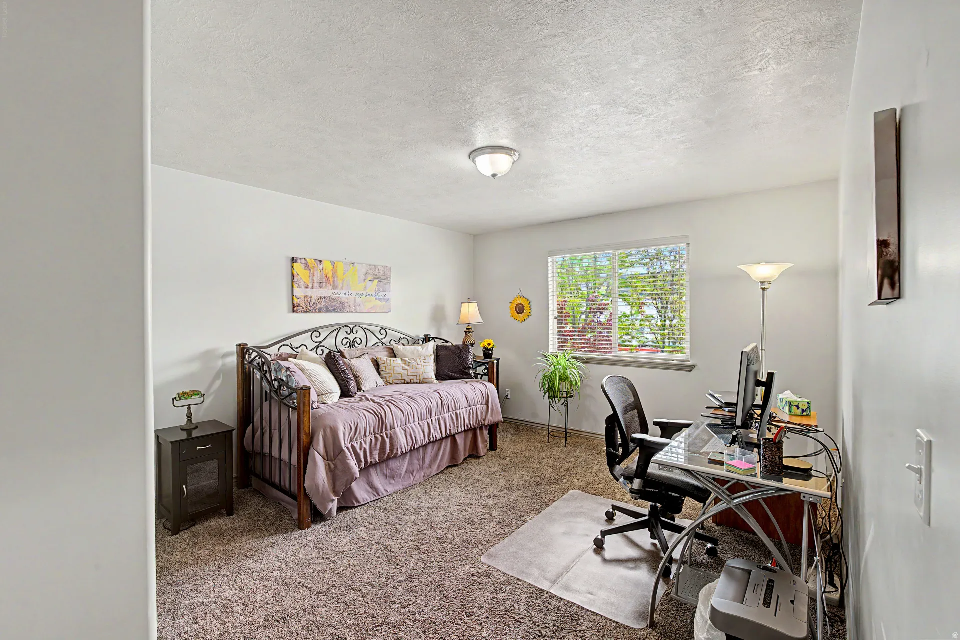 Carpeted bedroom with an office area