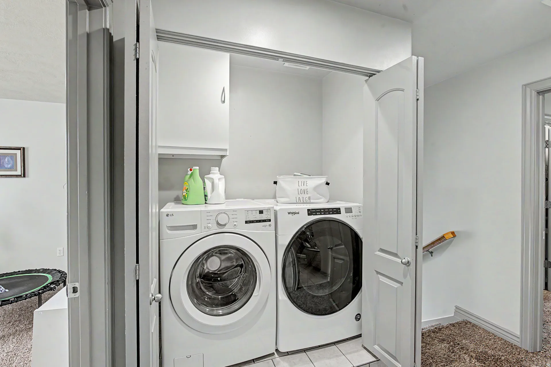 Laundry area with washer and clothes dryer and baseboards