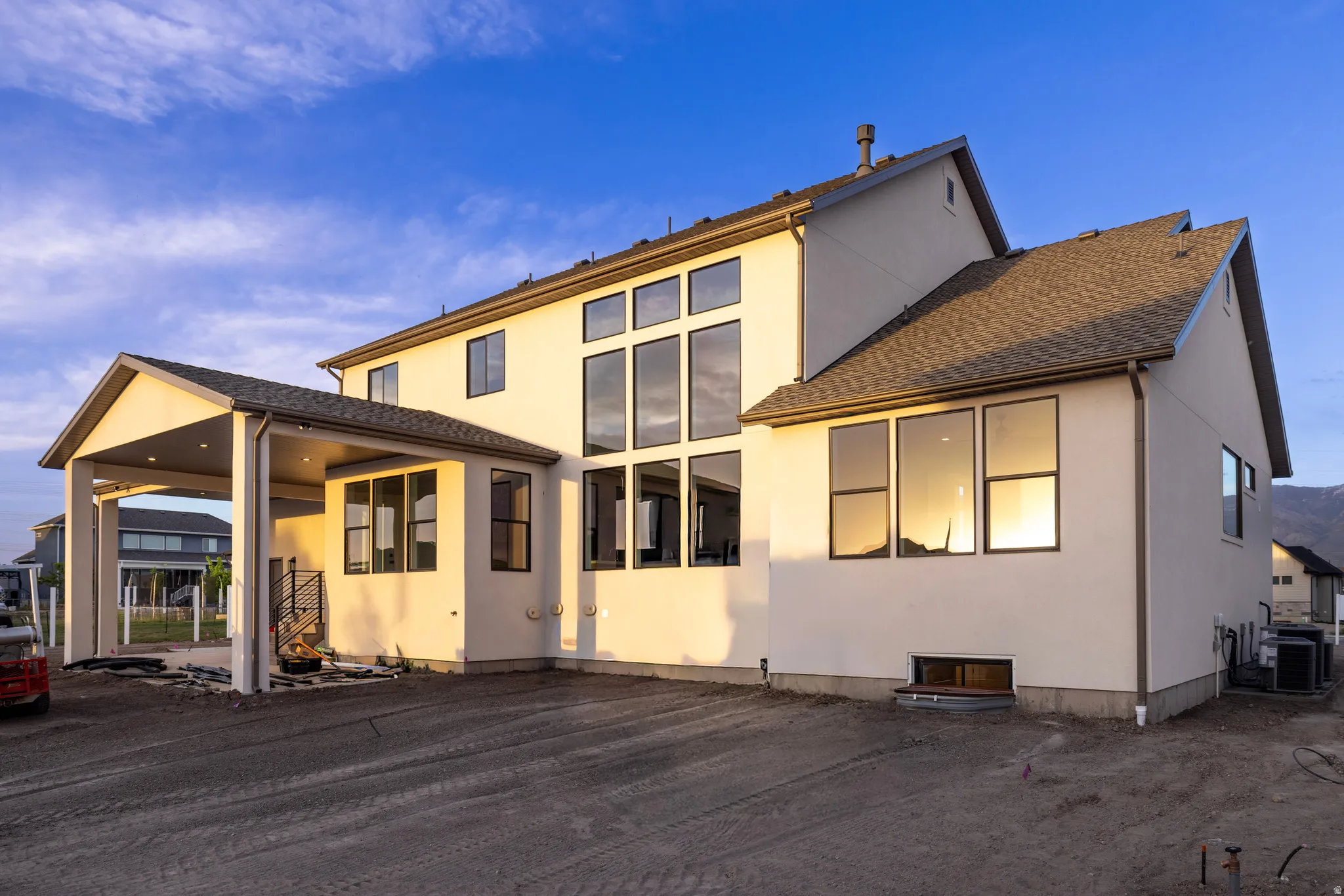 Rear view of house with stucco siding and a patio area