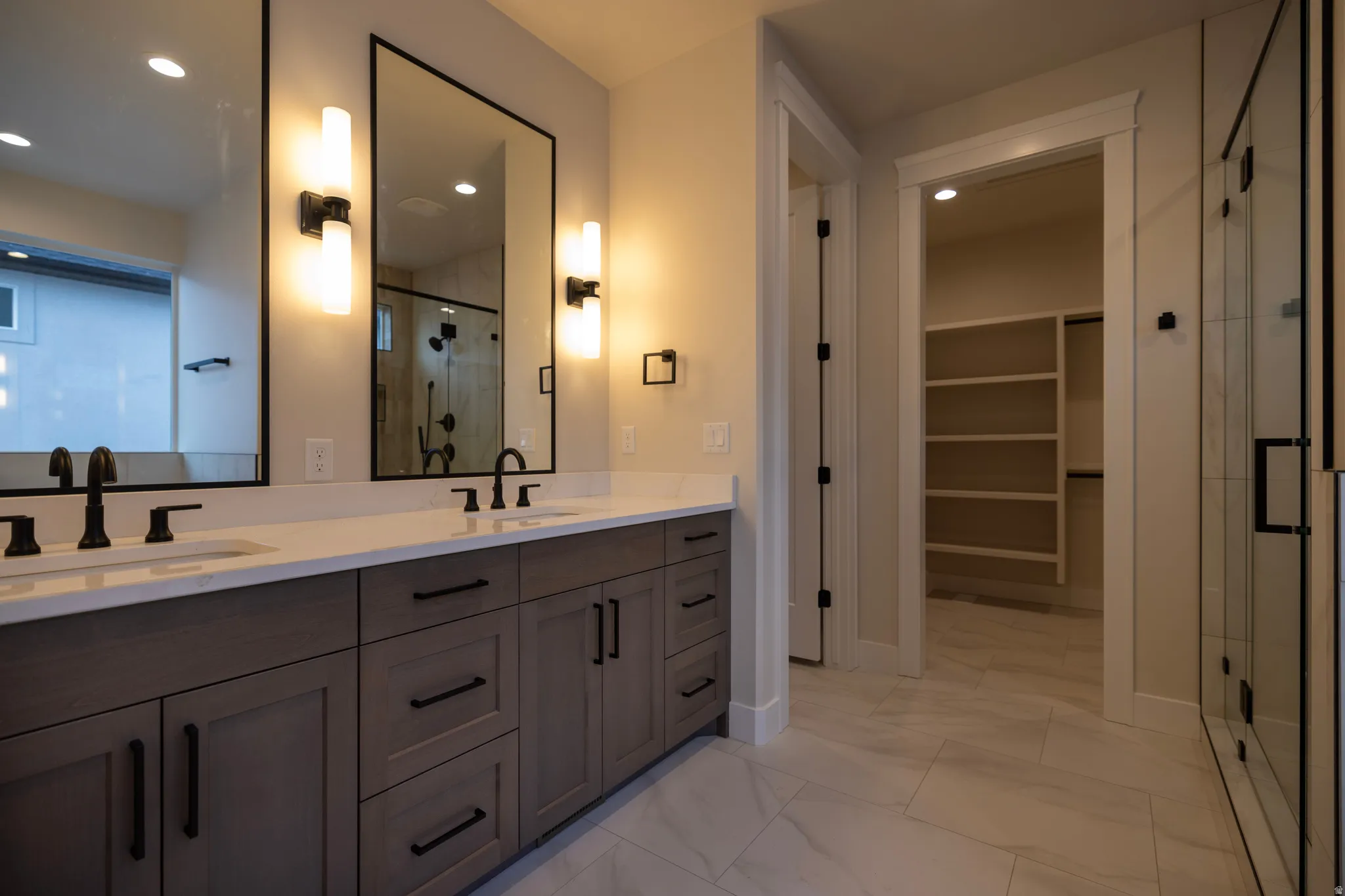 Master Bathroom with double vanity, a walk in closet, and recessed lighting