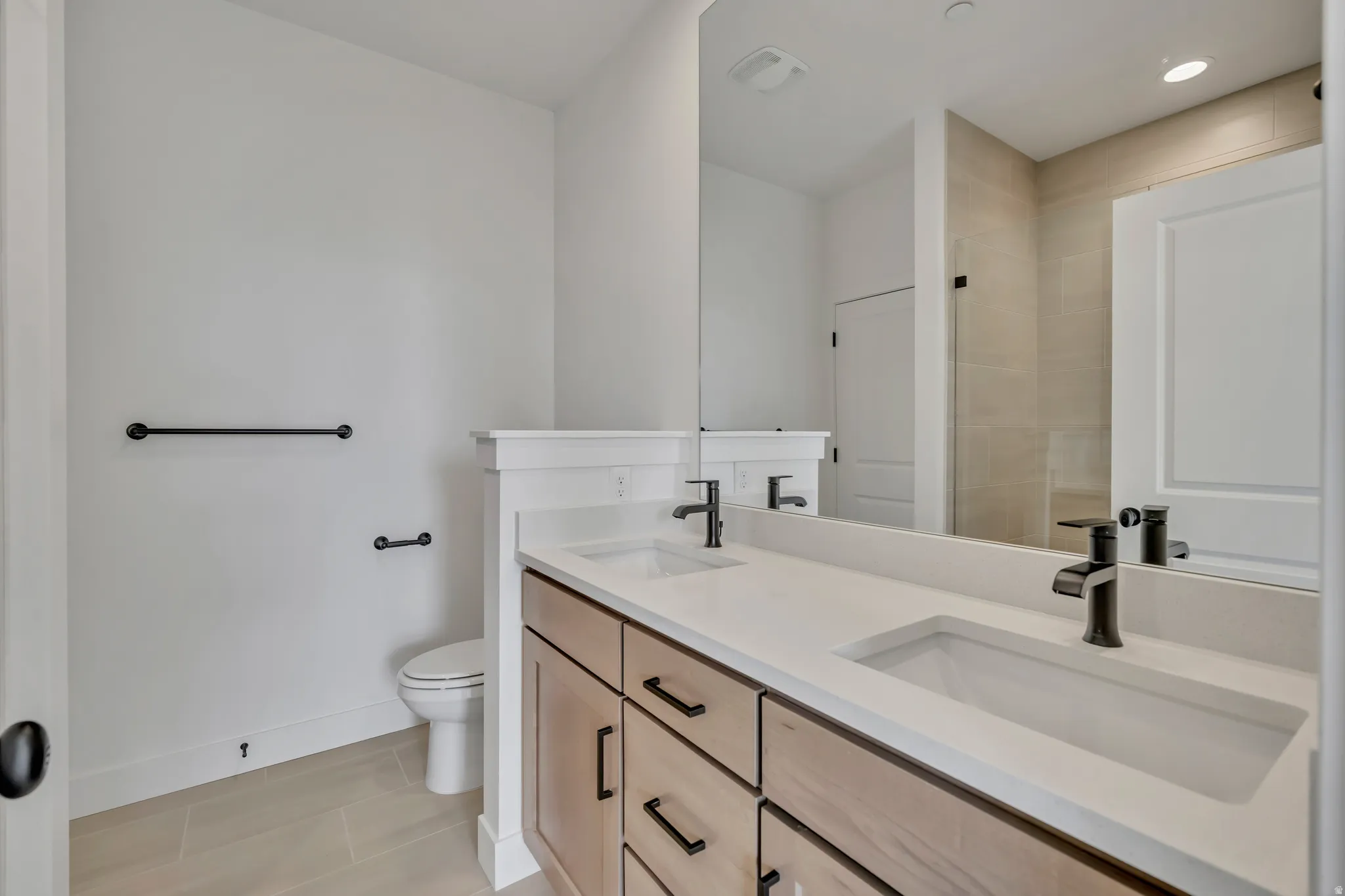 Bathroom featuring double vanity and toilet