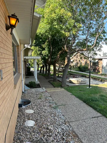 Brick exterior with a traditional wall-mounted lantern and a gravel rock bed