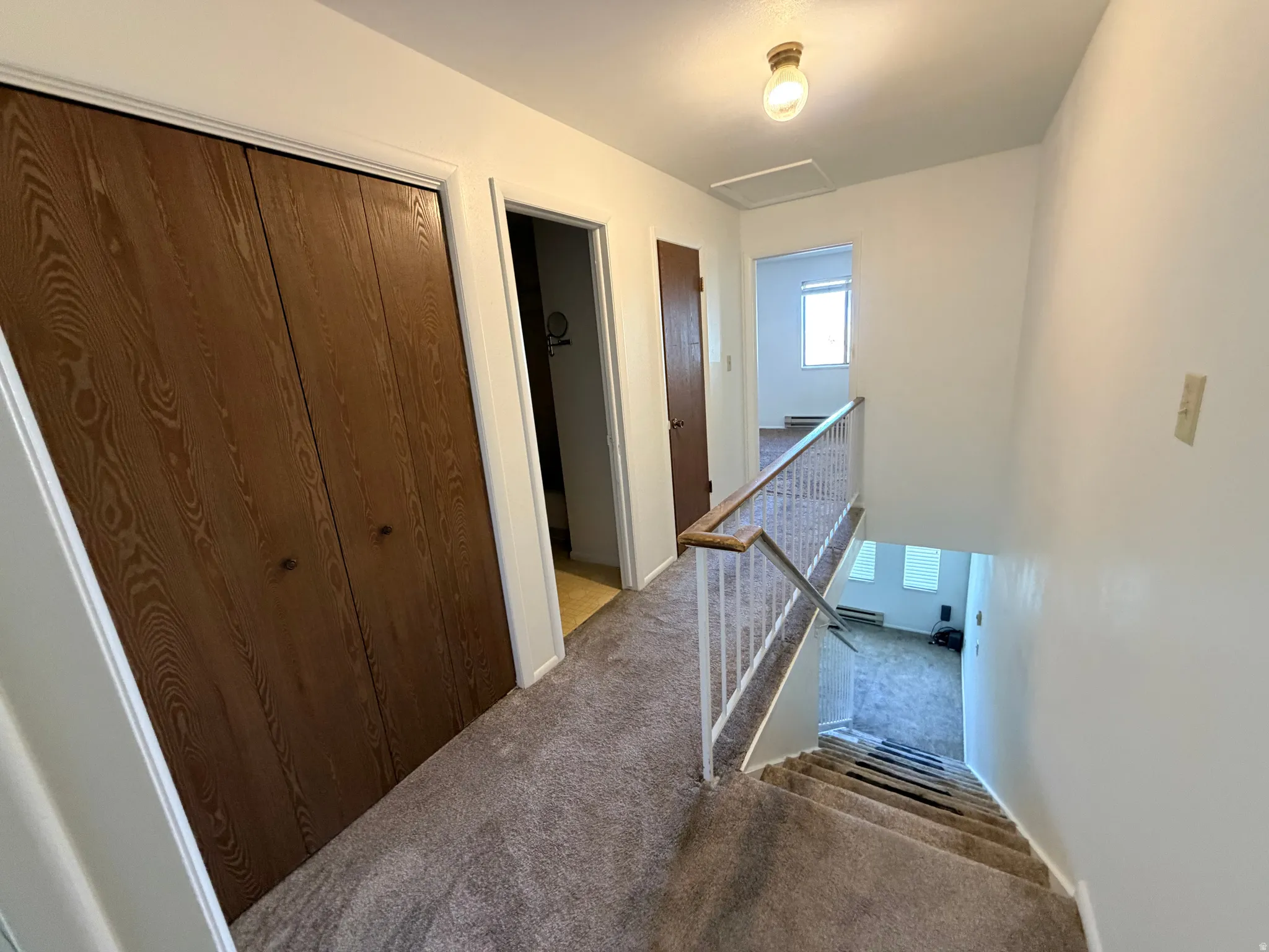 Hall with an upstairs landing and carpet floors