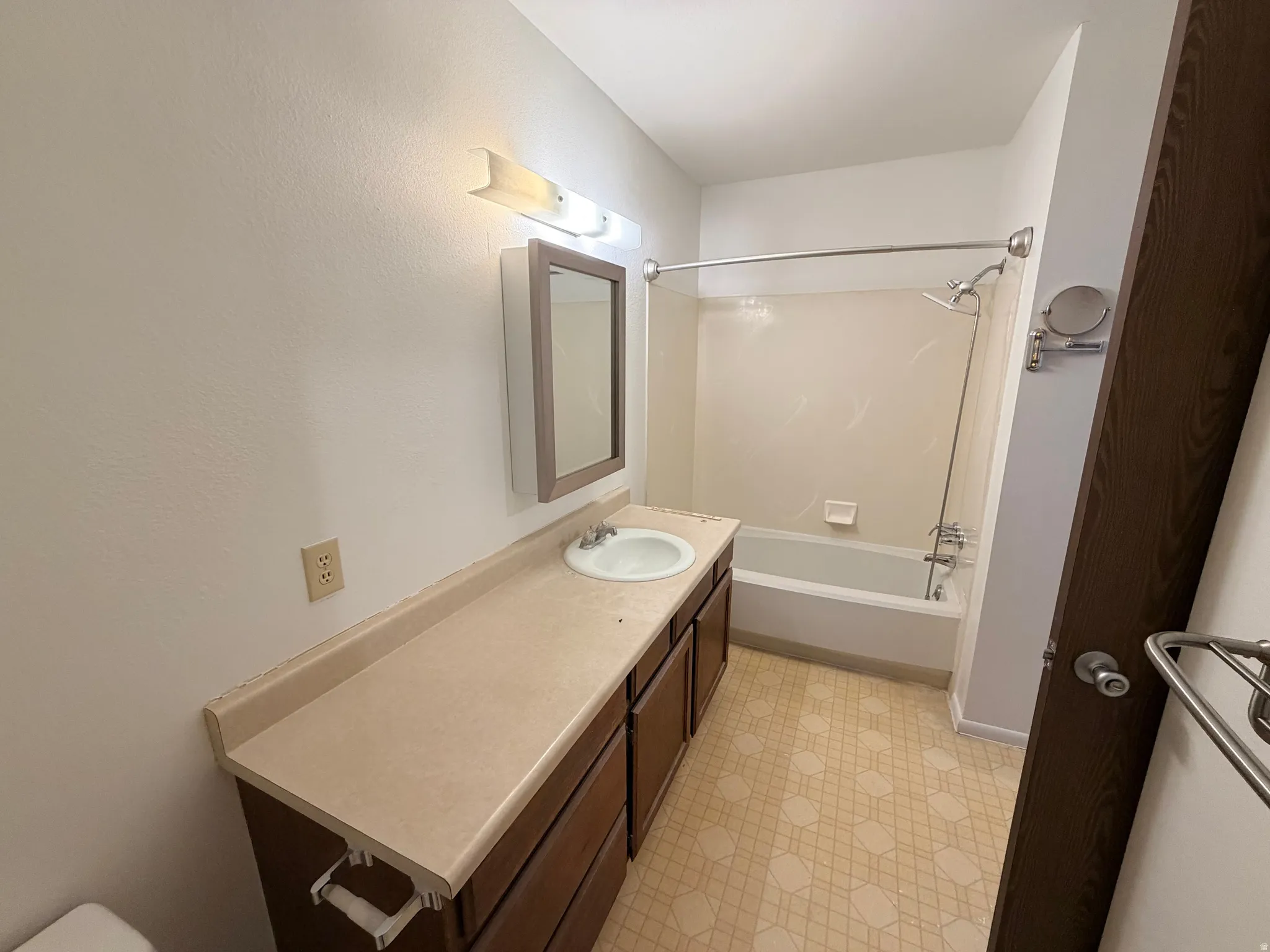 Full bathroom featuring vanity, light flooring, and shower / bathtub combination