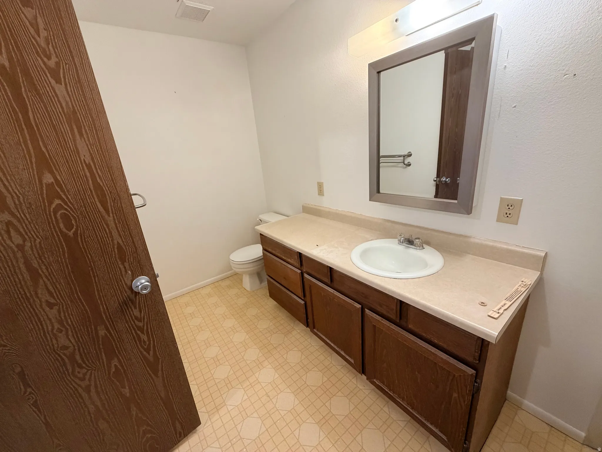 Bathroom featuring light flooring and vanity