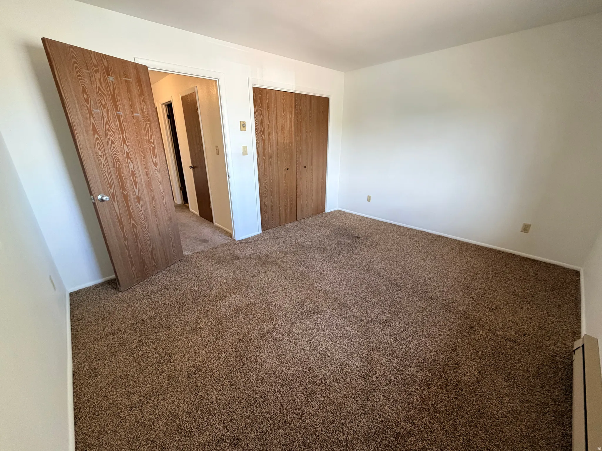 Unfurnished bedroom featuring carpet and a closet