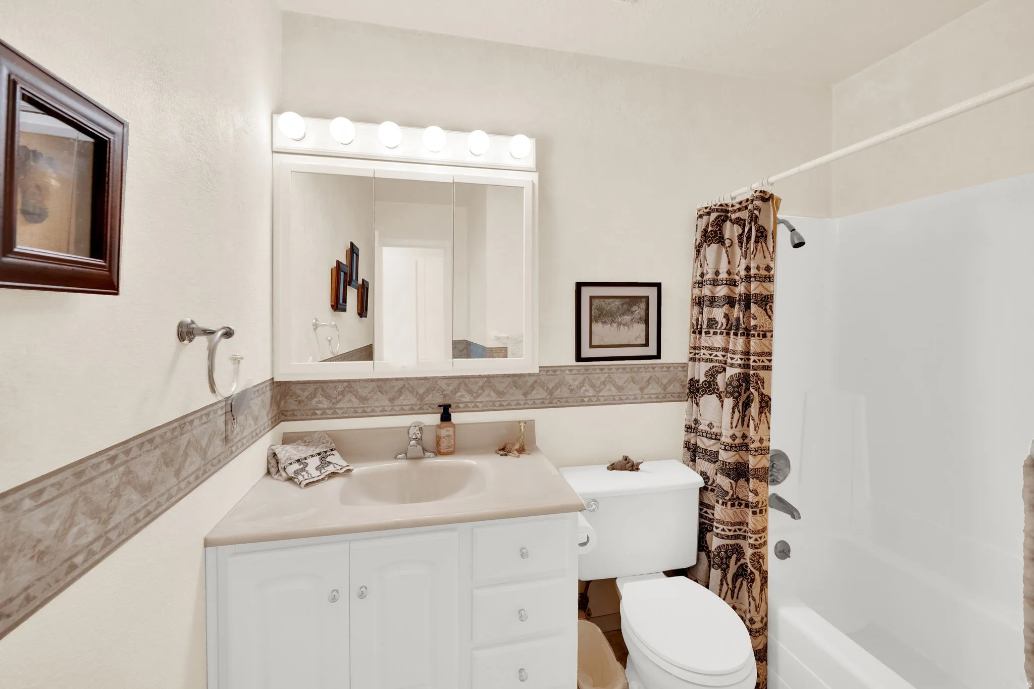 Full bath with vanity and shower / bath combination with curtain