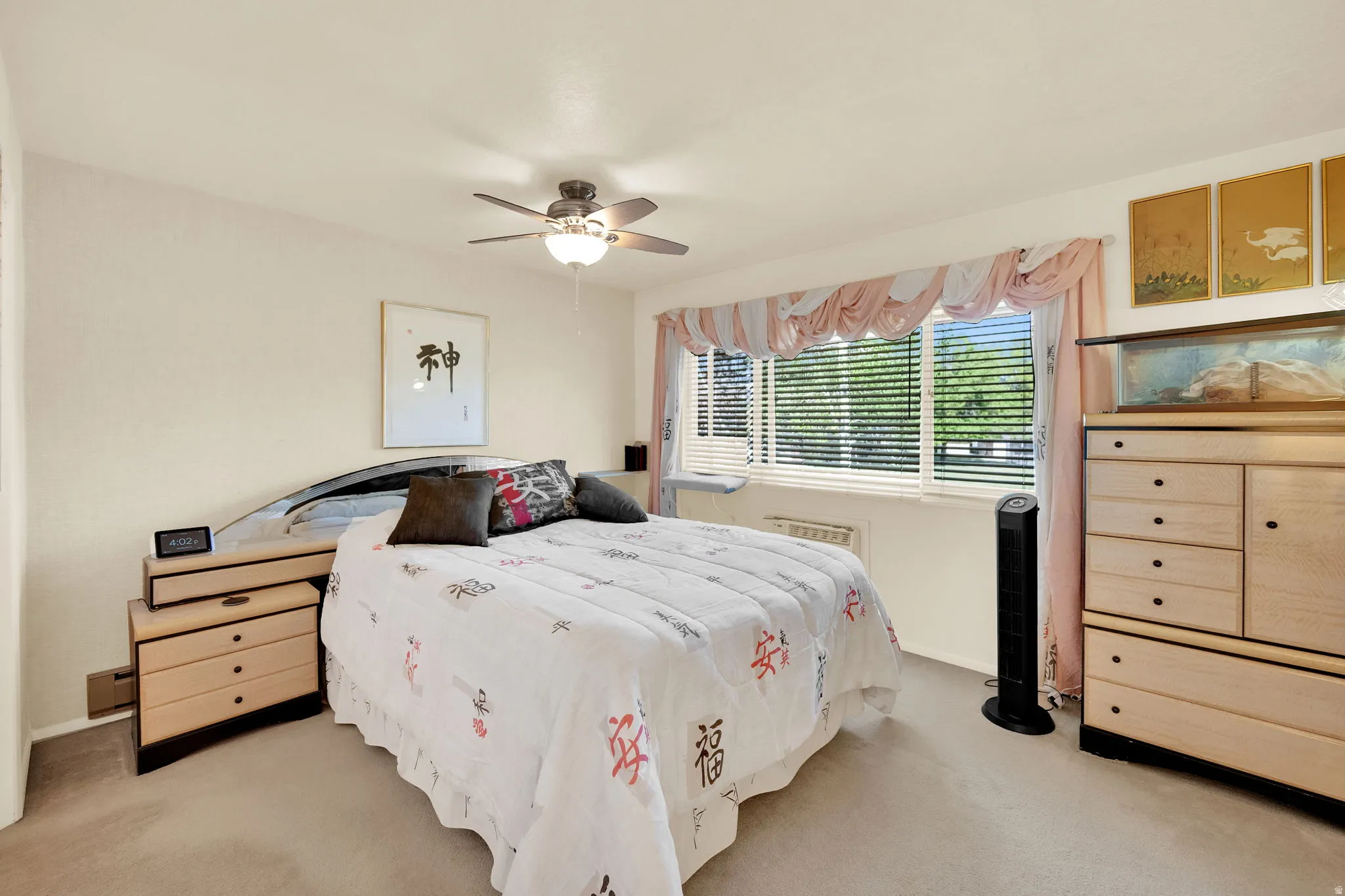 Bedroom with ceiling fan and light carpet
