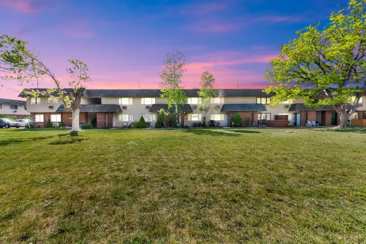 View of property at dusk