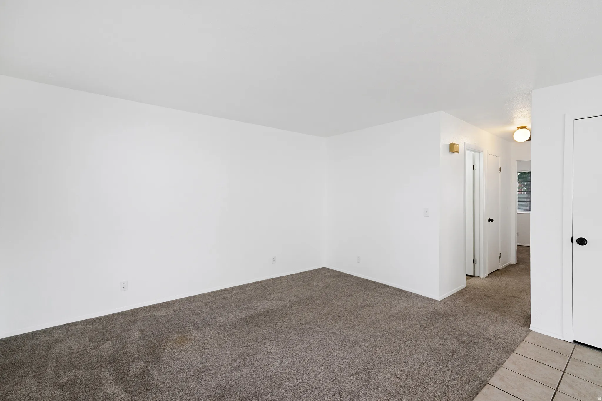 Living room featuring light carpet and light tile patterned floors