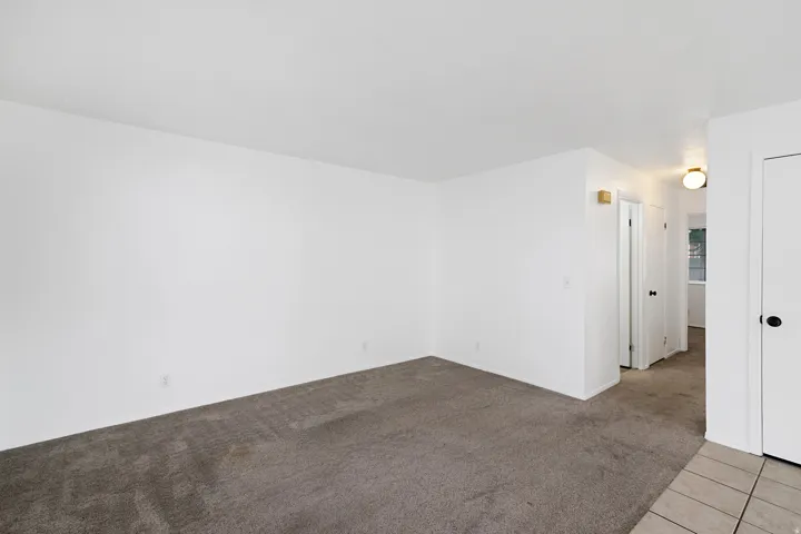 Living room featuring light carpet and light tile patterned floors