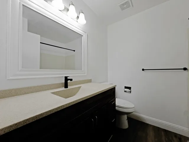 Bathroom featuring vanity and dark wood finished floors