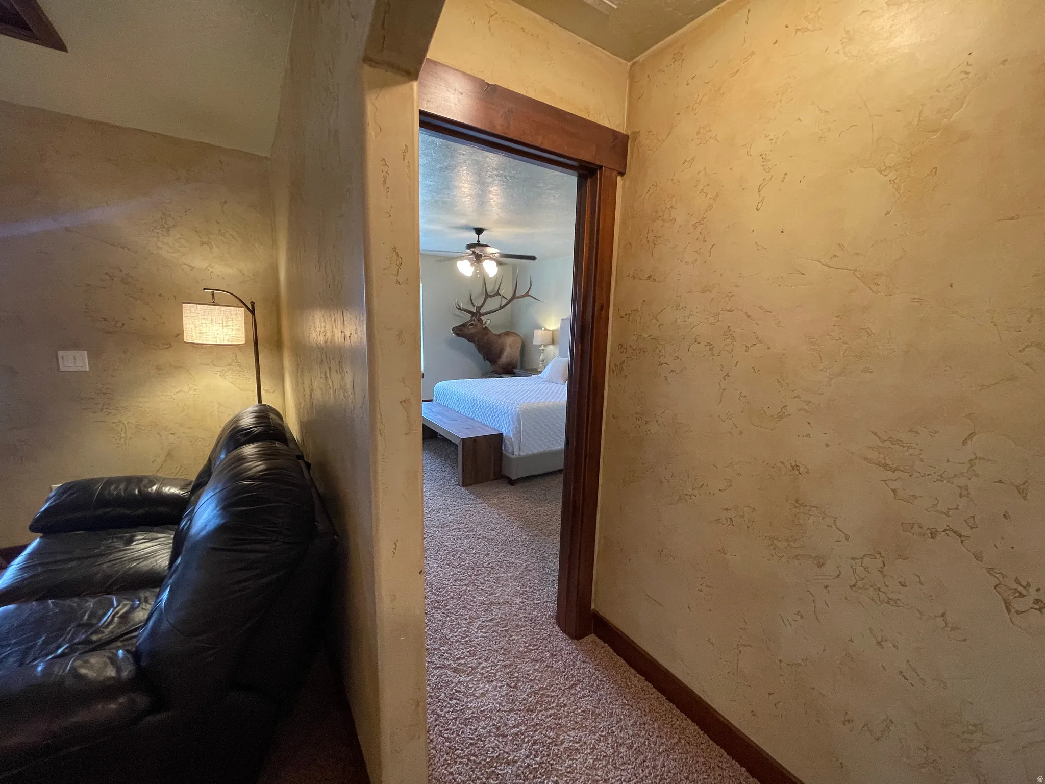 Hall featuring carpet and baseboards