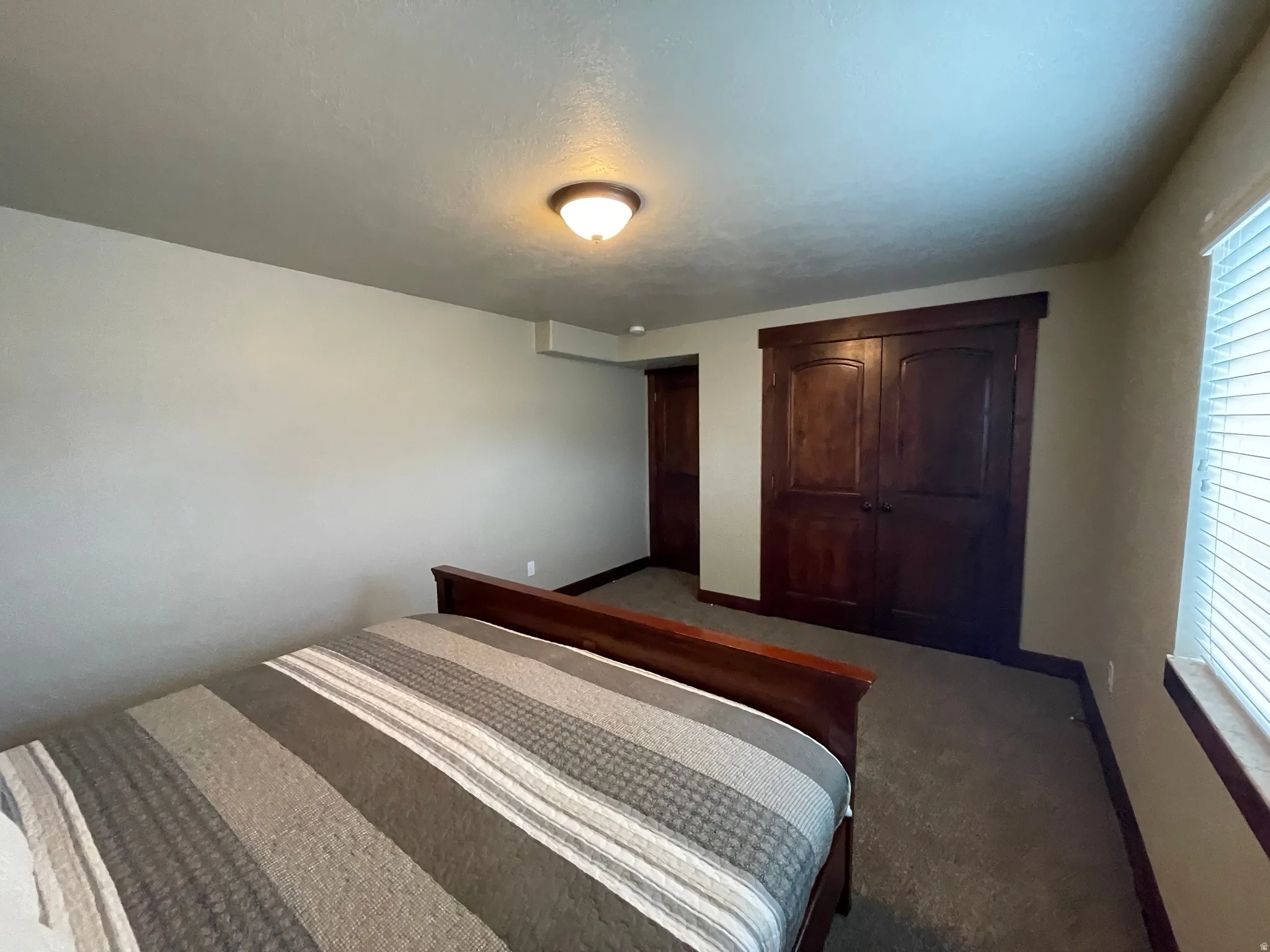 Bedroom with carpet flooring and a closet