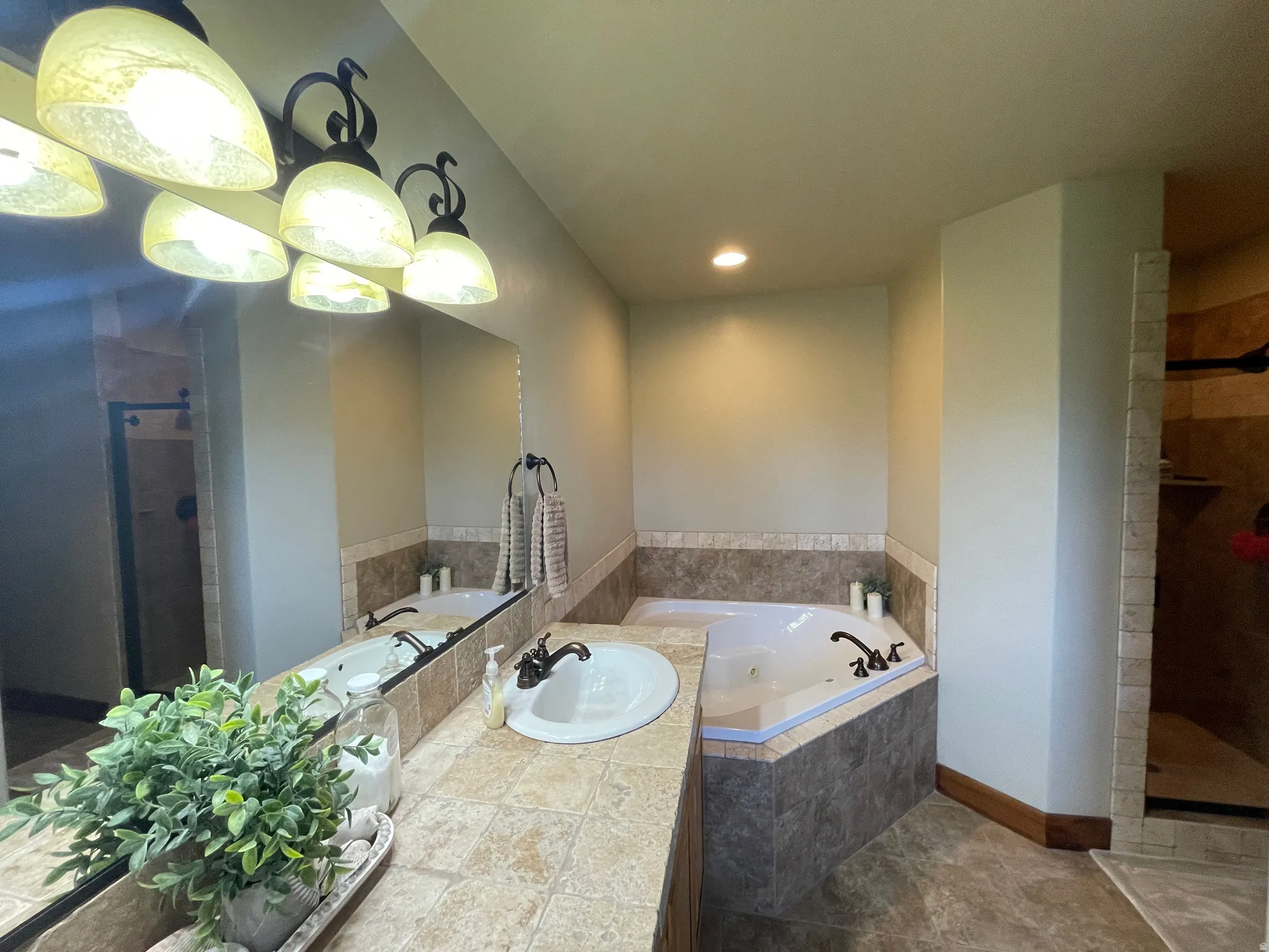 Bathroom with a shower stall, a jetted tub, vanity, and recessed lighting